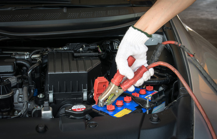 automotive technician charging vehicle battery automotive technician charging vehicle battery