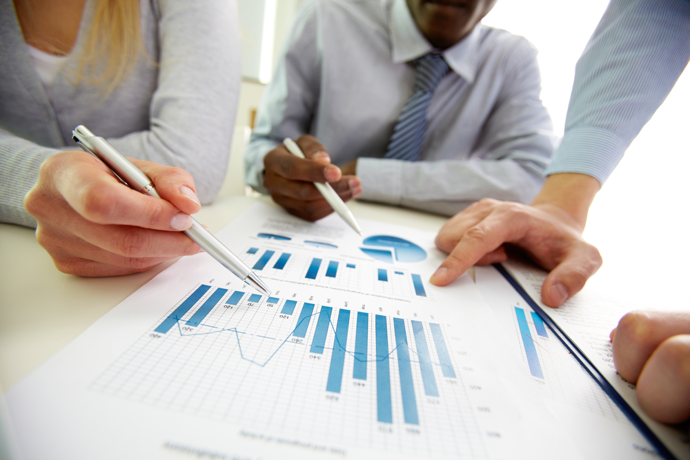 Impressive figures Business people discussing the charts and graphs showing the results of their successful teamwork